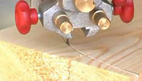 Bandsaw blade cutting into wood